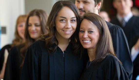 Two Western Law students pose inside Althouse College