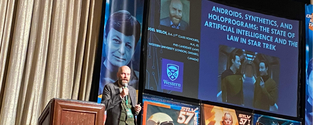 Jowl Welch presents on stage at the 2023 Star Trek conference